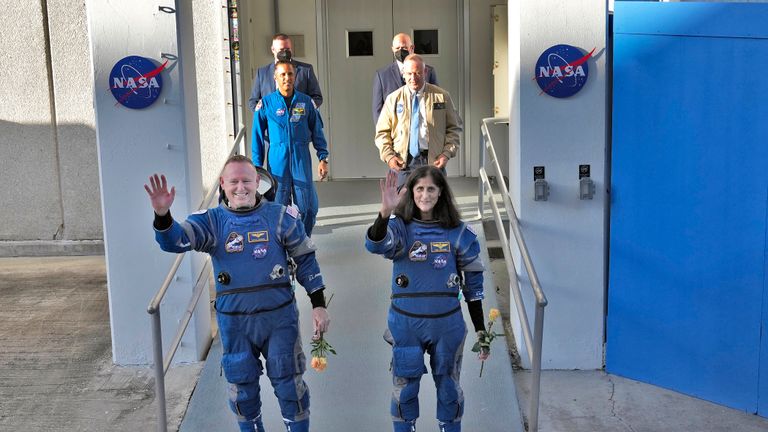 NASA astronauts Butch Wilmore, left, and Suni Williams waves to photographers after leaving the operations and checkout building for a trip to launch pad at Space Launch Complex 41 Wednesday, June 5, 2024, in Cape Canaveral, Fla. The two astronauts are scheduled to liftoff later today on the Boeing Starliner capsule for a trip to the international space station. . (AP Photo/Chris O'Meara)